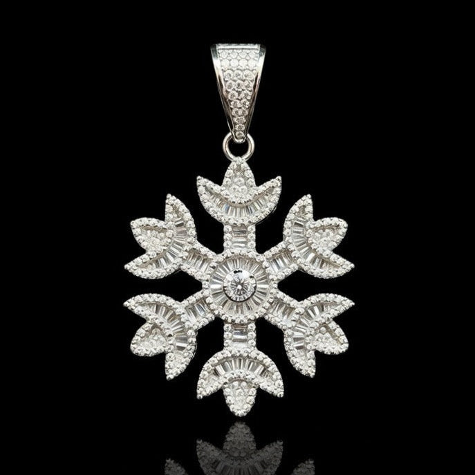 Silver snowflake pendant fully covered in pavé-set stones, photographed against a pure black background.
